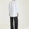 Asymmetrisk skjorte i poplin med paljetter Asymmetrisk skjorte i poplin med paljetter